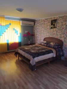a bedroom with a bed and a colorful wall at Центр Апартаменти готель ГРАН in Poltava +2 photos