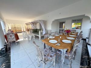 a dining room with a wooden table and chairs at White House villa in Malindi