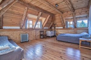 a room with two beds in a log cabin at Nadgora SkyHouse in Žabljak