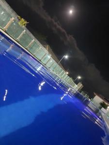a view of a swimming pool at night at Vog caruaru in Caruaru