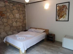 a bedroom with a bed and a stone wall at Marina Park in Vama Veche +21 photos