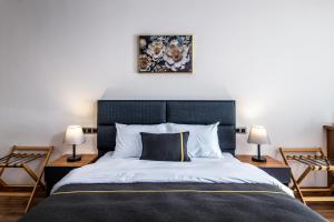 a bedroom with a large bed with two lamps at sh hotel business in Karşıyaka