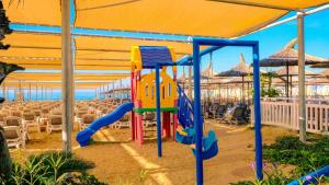 a playground in a tent with tables and chairs at Dream World Resort & Spa in Side