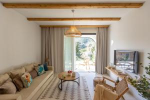 a living room with a couch and a table at Aella Exclusive Residences Lefkada in Mikros Gialos