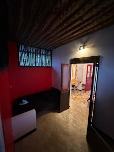 a room with a bed and a red wall at PointBreak Resort in Kalpitiya +7 photos