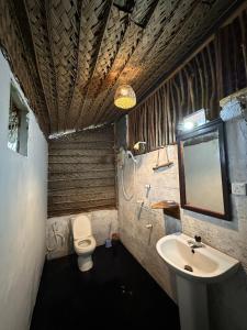 a bathroom with a sink and a toilet at PointBreak Resort in Kalpitiya