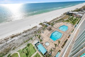 an overhead view of a beach with two swimming pools at The Summit 1426 in Panama City Beach