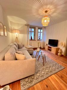a living room with a couch and a television at Ferienhaus am Markt - ANNO 1708 - App 2 in Aschersleben