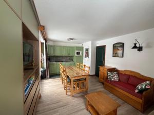 a living room with a red couch and a table at Chalet du Galibier Valloire in Valloire