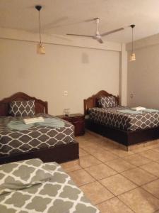 Postel nebo postele na pokoji v ubytování Hotel Colonos Los Cabos