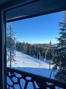 a view of a ski slope from a window at La Familia in Jahorina