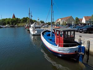 a small boat is docked in the water at Ostseeblick in Kirchdorf