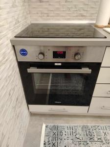 a kitchen with an oven with a clock on it at Star Apartment Belgrade 1 in Belgrade +38 photos