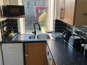 a kitchen counter with a sink and a window at Central Halifax Work & Retreat Base - Two bedroom house - sleeps up to 4 - free parking and internet in Halifax