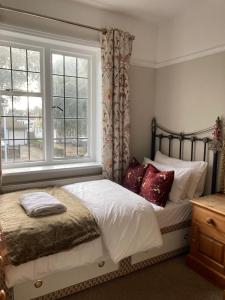 a bedroom with a bed with a window at The mole hole in Kent