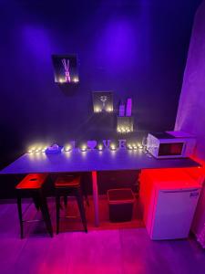 a purple room with a table with lights on it at 2eme in Lyon +9 photos