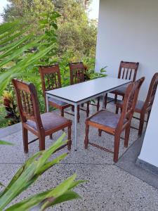 a table and chairs sitting around a white table and chairs at Diamond Coast Villa and Apartment in Paje