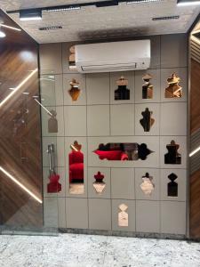 a room with a wall with a display of shoes at HOTEL PREMIER CHOICE - JUST 50 Meters FROM AJMER SHARIF DARGAH in Ajmer
