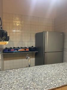 a kitchen with a stainless steel refrigerator and tiles at Tota house in dahab in Dahab