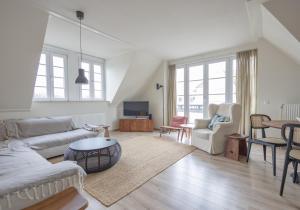 a living room with a couch and a table at Duinhof I 15 in Cadzand