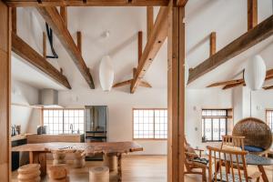 a kitchen and dining room with wooden beams at 蔕 Heta Nozawa Onsen in Nozawa Onsen