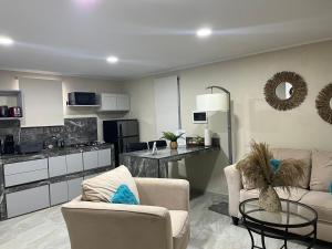 a living room with a couch and a table and a kitchen at Cozy 1-bedroom apartment minutes away drive to Mangel Halto Beach in Savaneta