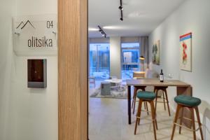 a room with a table and chairs and a dining room at Nomads Lux Studios & Business Center in Ioannina