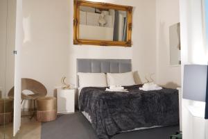 a bedroom with a bed with a mirror on the wall at THE GRAND VIEW Lux Vatican Suite in Rome