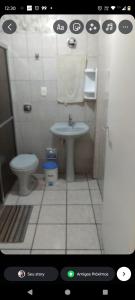 a bathroom with a sink and a toilet at Apartamento na praia grande in Praia Grande