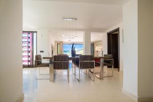 a dining room with a table and chairs at Villa Luštica, Spacious 4-Bedroom Villa with Private Pool in Luštica