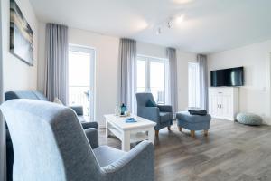 a living room with two chairs and a table at Seaside 49 3 N in Wangerland