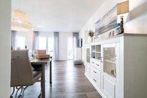 a kitchen and dining room with a table and a dining room at Seaside 49 3 N in Wangerland