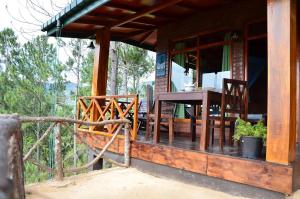 a porch of a house with a table and chairs at Ella Mount Relax Cottage in Ella +57 photos