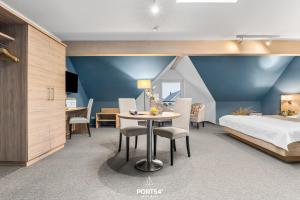 a bedroom with a bed and a table and chairs at Ferienwohnung Bude 12 Dagebüll in Dagebüll