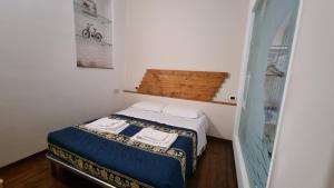 トロペアにあるLady Saturno's Homeの小さなベッドルーム(ベッド1台、タオル2枚付)