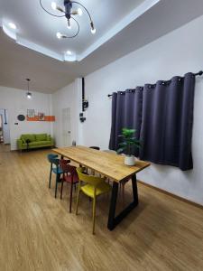 a conference room with a wooden table and chairs at Dollar Betong homestay in Ban Komo Sip Paet