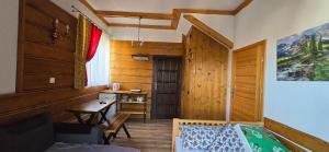 a bedroom with a bed and a desk in a room at Pokoje Gościnne U Ogórków in Witów