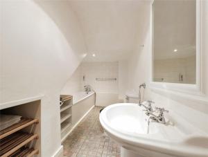 a white bathroom with a sink and a tub at AzZule - Tynemouth in Tynemouth