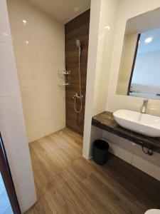 a bathroom with a sink and a shower at Nagoya Thamrin Cozy Apartment 11TH City View in Nagoya