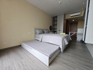 a large bedroom with two beds and a staircase at Nagoya Thamrin Cozy Apartment 11TH City View in Nagoya