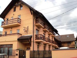 a building with balconies on the side of it at Pension Bittner in Braşov