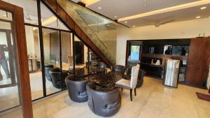 a living room with a table and some chairs at Nivasa Villa - 5 BHK Triplex House Near Cyberhub in Gurgaon