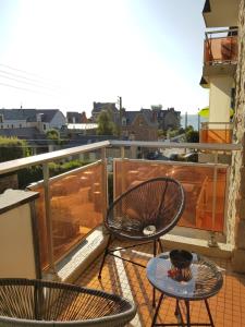 a balcony with two chairs and a table at Kavell in Pléneuf-Val-André