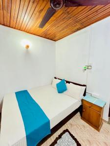 a bedroom with a bed and a wooden ceiling at Ranga's House in Weligama