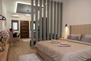 a bedroom with a large bed with two pillows on it at Celestia House in Kalabaka