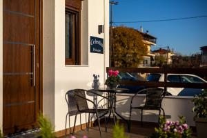 a patio with a table and chairs on a balcony at Celestia House in Kalabaka