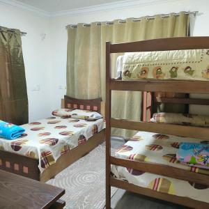 a bedroom with two bunk beds and a table at العاصمة الإدارية in Cairo