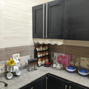 a kitchen counter with cups and utensils on it at العاصمة الإدارية in Cairo