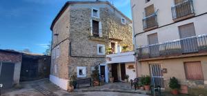 an old stone building with a bench in a courtyard at Can Manuel in Gabet