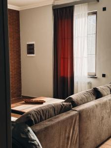 a living room with a couch and a window at dili hill in Dilijan +15 photos